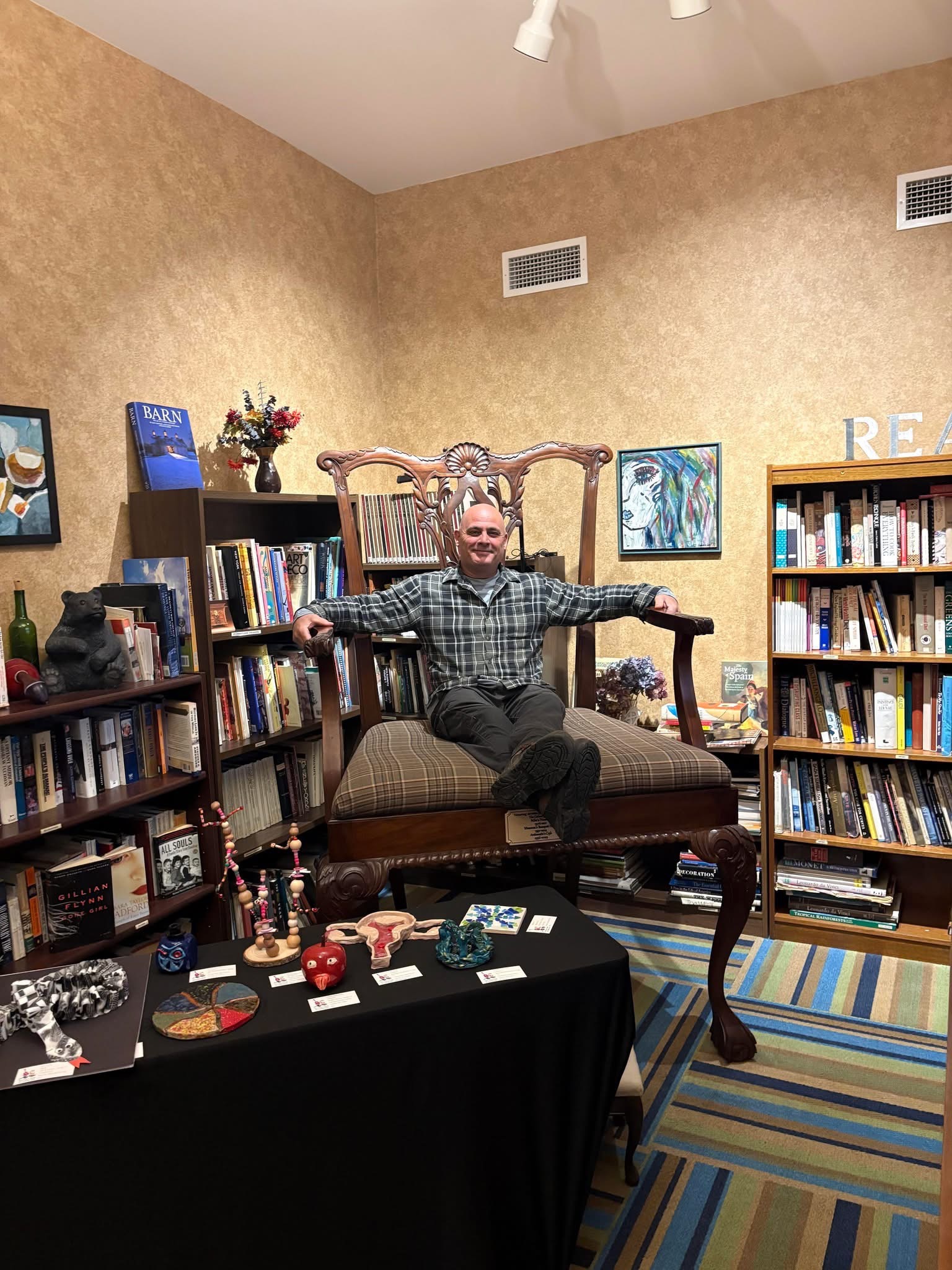 Michael J. Betanzos Jr. seated in a reading room