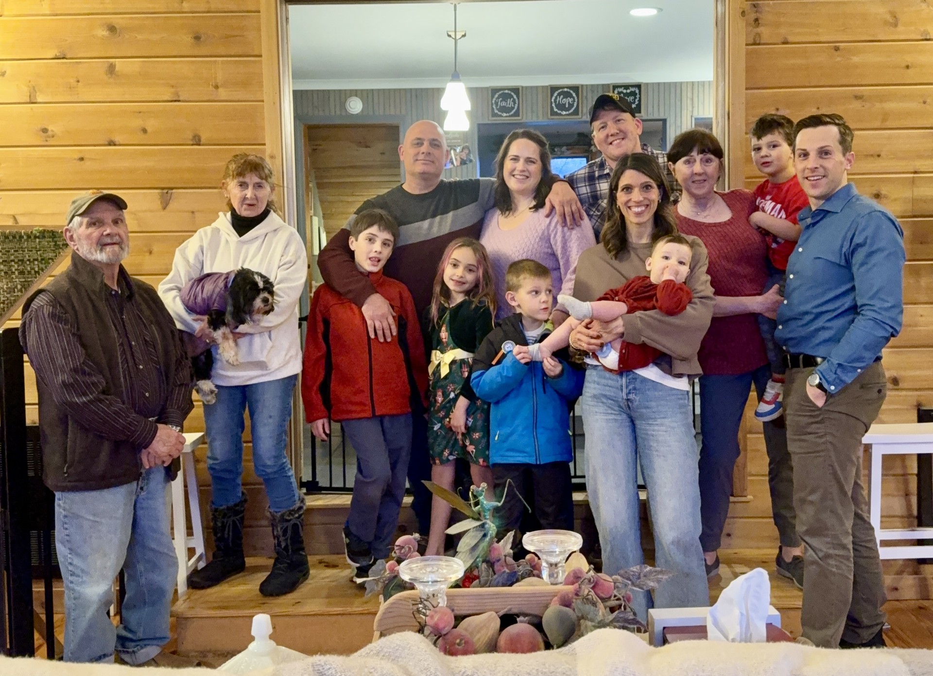 Large family group photo inside a cabin