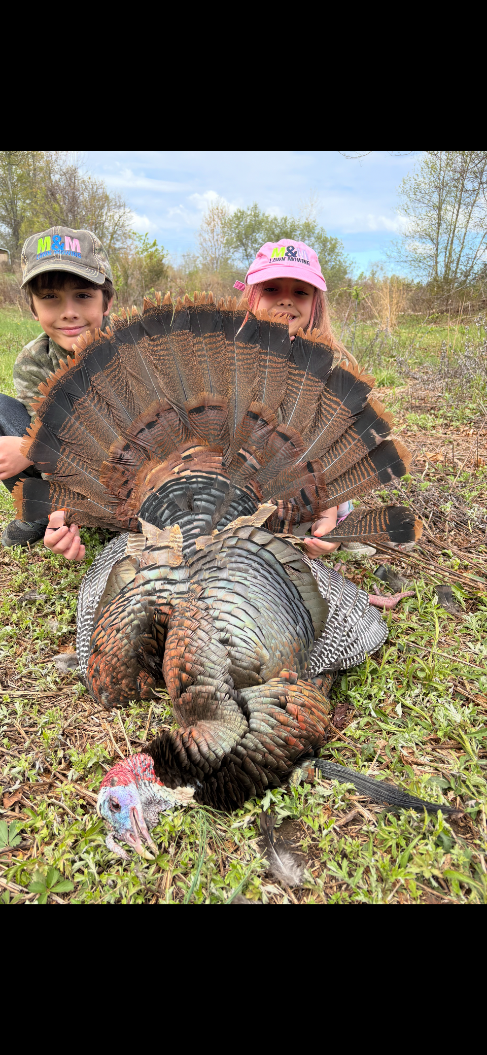 Children outdoors with a turkey